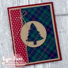 a christmas card with a plaid background and a tree on the front, which is attached to a button