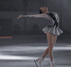 a female figure skating on an ice rink