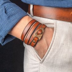 a close up of a person wearing a leather bracelet