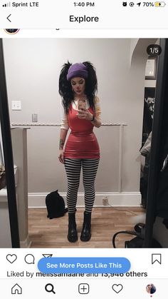 a woman taking a selfie in front of a mirror wearing tights and boots