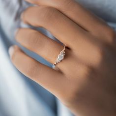 a woman's hand with a diamond ring on it