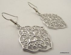 These earrings are so feminine and stunning. They are perfect for any occasion. These earrings feature an ornate silver plated floral charm finished off with stainless steel ear wires, for those with sensitive ears. The ear wires can be switched out to silver plated clip-ons, for those with non-pierced lobes. Simply select that option before adding to your cart. Height from top of ear wire to bottom: 2 inches Width: 1 inch Check the online store to see if this style is available in other finishe Elegant Hypoallergenic Metal Flower Earrings, Elegant Hypoallergenic Silver Flower Earrings, Elegant Nickel-free Metal Flower Earrings, Nickel Free Silver Metal Flower Earrings, Nickel-free Silver Metal Flower Earrings, Elegant Silver Metal Flower Earrings, Silver Metal Flower Earrings With Ear Wire, Silver Flower Earrings With Ear Wire, Silver French Hook Jewelry For Wedding