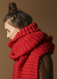 a woman wearing a red knitted scarf