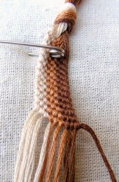 a close up of a piece of yarn with a needle