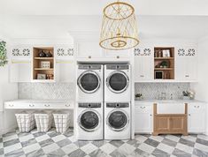 a washer and dryer in a white kitchen with checkered flooring on the floor