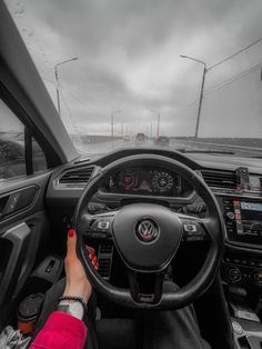 a person driving a car on a cloudy day