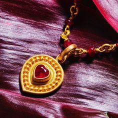 A unique take on a classic design, this pendant features a heart-shaped ruby framed by granules of gold. A very special gift for someone who holds your heart! Please note that pendants are sold separately from chains. 20K Peach Gold Heart-shaped ruby, 1.10 cwt Pendant Measures 19mm; Hangs 30mm Style Number: PP62SALHEART Hand fabricated in our New York City design atelier & workshop Traditional Heart-shaped Yellow Gold Jewelry, Gold Ruby Heart Pendant Jewelry, Gold Pendant Heart Necklace With Gemstone, Heart-shaped Ruby Necklace In Yellow Gold, Gold Double Heart Gemstone Necklaces, Yellow Gold Ruby Heart Pendant Necklace, Traditional Yellow Gold Jewelry For Valentine's Day, Ruby Heart Charm Jewelry, Valentine's Day Yellow Gold Ruby Necklace