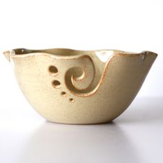 a white bowl with gold swirls on it