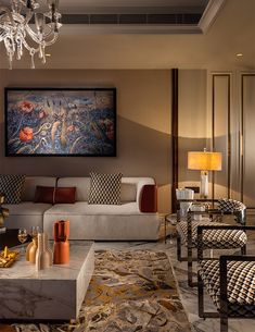 a living room filled with furniture and a chandelier hanging above the couches