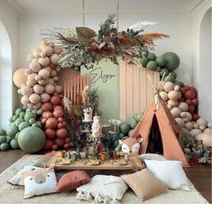 a room filled with lots of different types of balloons and decorations on the wall, including a teepee tent