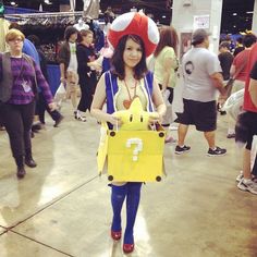 a woman dressed in pokemon costume holding a yellow bag