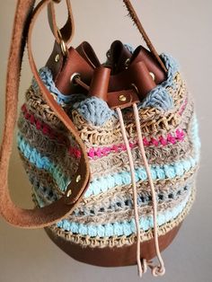 Petite Sky-Blue - our series of bucket bags.  This colorful and beautiful bucket bag is a combination of knitwear, crochet, and leather. The creation has a cylindrical-shaped leather base that gives solidity to the whole frame of the bag. The bag is fully hand-knitted and hand-sewn. We use natural jute twines of different sizes to ensure further steadiness of our knitwear. Despite the bucket bag's small size, it still provides enough space for basic items. Bag Dimensions:  Leather Base: flat (fo Casual Handwoven Bucket Bag, Leather Crochet Bucket Bag With Braided Handles, Everyday Woven Leather Bucket Crochet Bag, Everyday Woven Leather Crochet Bucket Bag, Handmade Casual Crochet Bucket Bag, Casual Handmade Crochet Bucket Bag, Bohemian Crochet Bucket Bag With Leather Handles, Brown Bucket Crochet Bag, Handwoven Crochet Bucket Bag For Everyday Use