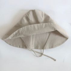 Nothing embodies summer quite like a wide-brimmed, floppy hat. But, this is no ordinary sun hat! Mindfully made from the softest organic linen and designed with a soft structured brim, it’s simply the most stylish way to shade your eyes (it even has a handy chin tie for breezy beach days). GOTS certified and free from harmful chemicals, our organic linen is luxuriously airy. It’s sourced from rare organic flax from the mountains of France to retain its durable, rustic appearance yet incredibly s Cream Sun Hat For Everyday Summer Use, Linen Fedora Hat For Spring, Casual Beige Linen Hat, Natural Linen Hats For Spring, Natural Hemp Sun Hat With Curved Brim, Natural Linen Hat For Spring, Summer Linen Hat With Short Brim, Beige Cotton Summer Sun Hat, Linen Bucket Hat For Spring