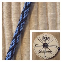 a blue and white clock sitting on top of a bed next to a piece of cloth