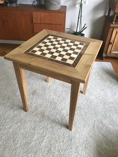 a wooden table with a chess board on it in the middle of a living room