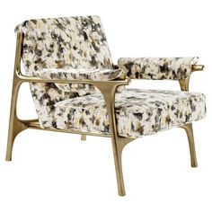 an upholstered chair with a gold frame and black and white patterned fabric on it