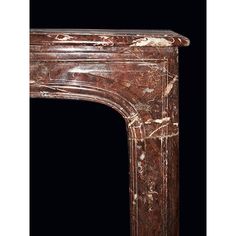 an old fireplace with marble work on the top and bottom part, in dark background