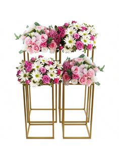 three gold plant stands with pink and white flowers on each side, one holding a bouquet