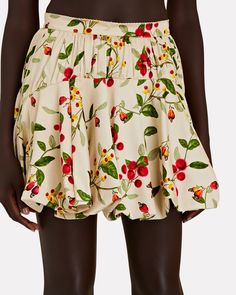 Agua by Agua Bendita's Hinojo mini skirt has an artfully gathered hem that'll create beautiful movement when you walk. It's made from soft sateen with vibrant botanicals– try yours with the matching Mulato crop top. Side slit pockets.   Fabric: 53% recycled viscose, 47% viscose.  Lining: 100% cotton.   Concealed back zip closure.   Dry clean.   Imported.       Length from waist to hem: 17".   Model is wearing size S.  Model height 5'11", bust 32", waist 24.5", hips 34.5". Printed Mini Skirt, Model Height, Mini Skirt, Crop Top, Mini Skirts, Dry Clean, Crop Tops, How To Wear