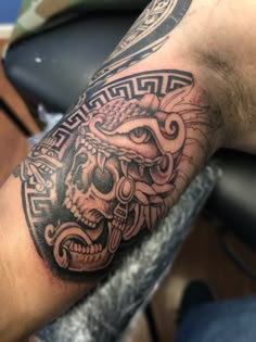 a man's arm with a tattoo on it and a skull in the middle