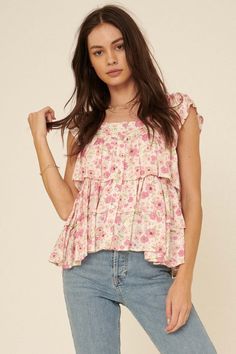 Floral-print jacquard blouse. Scoop neckline. Button-front closure with pearly buttons. Ruffled cap sleeves. Tiered ruffle silhouette. Low back. Relaxed fit. 100% Rayon. Imported. Designed in Los Angeles, CA. Model wears size S. Pink Ruffled Square Neck Top, Pink Square Neck Top With Ruffles, Tiered Pink Tops For Spring, Casual Tiered Floral Print Top, Casual Tiered Tops With Floral Print, Feminine Square Neck Top With Ruffles, Casual Pink Tiered Top, Pink Ruffled Collar Top For Summer, Feminine Tiered Ruffle Tops