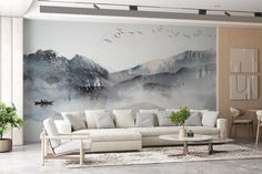 a living room filled with furniture and a painting on the wall above it's couches