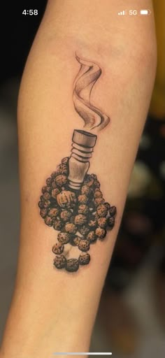 a small tattoo with a light bulb on top of some nuts and coffee beans in it