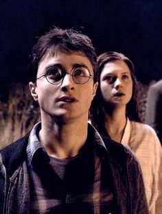 harry potter and hermione are standing in the dark