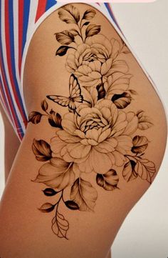 a woman's thigh with flowers and butterflies on it