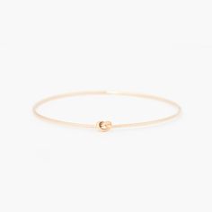 The Original Knot Bangle – Yearly Co. Adjustable Minimalist 14k Gold Bangle, Everyday Sliding Knot Bangle Jewelry, Everyday Bangle Jewelry With Sliding Knot, Minimalist Hoop Bangle As Gift, Minimalist Sliding Knot Bracelet Jewelry, Minimalist Hand Wrapped Bangle Bracelet, Adjustable Bangle With A Modern Twist For Gifts, Adjustable Bangle With A Modern Twist As A Gift, Modern Twist Adjustable Bangle As A Gift