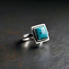 Discover the exquisite beauty of our Square Turquoise Ring, crafted from 925 silver. This stunning handmade jewelry piece features a vibrant turquoise stone, known for its unique color and natural healing properties. Perfect for adding a touch of elegance to any outfit, this ring is a must-have for jewelry lovers. Each piece is meticulously crafted, ensuring you receive a one-of-a-kind accessory. Ideal for gifting or treating yourself, elevate your jewelry collection with this timeless treasure. Shop now and embrace the allure of handcrafted elegance! DETAILS---- 1) Material - 925 Silver 2) Gemstone - Turquoise Care instructions: * Keep Jewellery away from water, perfumes, deodorants, and other strong chemicals as they may react with the metal or plating. * Wipe Jewellery gently with a sof Untreated Silver Turquoise Ring, Silver Rectangular Turquoise Gemstone Ring, Affordable Nickel-free Silver Turquoise Ring, Cheap Nickel-free Silver Turquoise Ring, Unique Silver Turquoise Nickel-free Ring, Natural Gemstone Jewelry, Timeless Treasures, Keep Jewelry, Jewelry Lover