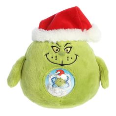 a green stuffed animal with a santa hat on