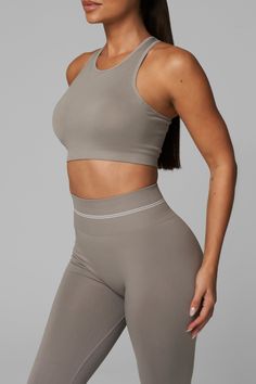 Introducing LiCi's True Form collection, a seamless activewear line that serves as a reminder to be true to yourself. Crafted with a fabric that feels silky smooth to the touch, and enhanced with a full interlocking knit construction, this collection offers the perfect combination of compression and breathability. Full Coverage Jewel Neckline With Removable Pads Racer Back 2-Tier Ribbed Under Band Detail With Multi-Support Compression Levels LiCi Logo placement center back Fabric: Seamless 90% N Sporty High-stretch Smoothing Activewear, Beige Stretch Athleisure Sports Bra, Micro-elastic Smoothing Sporty Activewear, Micro-elastic Sporty Activewear With Smoothing Details, Beige Compression Seamless Activewear, Beige Seamless Compression Activewear, Sporty Activewear With Smoothing Micro-elastic Fit, Sporty Micro-elastic Activewear With Smoothing Details, Versatile Sports Activewear With Smoothing Details