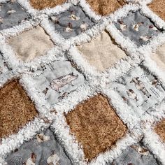 a close up of a quilt with animals on it