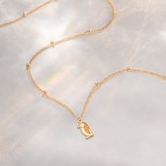 Embrace the charm and elegance of our Penguin Necklace, a delightful piece that brings the enchanting world of penguins to your jewelry collection. Available in 14k gold filled, sterling silver, or 14k solid gold, this necklace is perfect for animal lovers and those who appreciate unique, handcrafted jewelry. * We use the Highest Quality materials from the US and Italy. * Your purchase will come packaged and ready for gift giving! M A K E S * A * P E R F E C T * G I F T : ) * * * * * * * * * * * Penguin Necklace, Initial Disc Necklace, Engraved Bar Necklace, Silver Bar Necklace, Bar Necklace Personalized, Initial Necklace Gold, Bird Charm, Gold Bar Necklace, Bird Jewelry