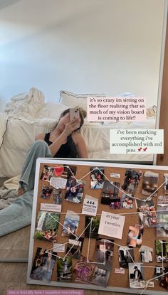 a woman sitting on the floor in front of a mirror holding up her cell phone