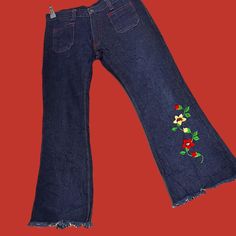 Rare *  Deadstock * Vintage 1970's  'Gold Star'  Dark Blue Jeans,  Flared Denim  Woodstock Hippie Bell Bottoms Featuring:  * Red / Yellow Floral Embroidery * Contrast Red Stitching Throughout * Raw Leg Hem * Flat Front  Pockets   * Zipper / Button Closure  * Pockets Front & Back * Belt Loops * Strong / Sturdy Denim Material  * Non-stretch * Original Labels Intact  Size ~27 Please verify measurements  * Excellent condition . Top Notch! Casual Embroidered Cotton Flare Jeans, Red Denim Flare Jeans For Spring, Spring Red Denim Flare Jeans, Embroidered Denim Blue Cotton Flare Jeans, Casual Embroidered Denim Blue Flare Jeans, Casual Embroidered Flare Jeans In Denim Blue, Cotton Hippie Flare Jeans For Spring, Spring Embroidered Cotton Flare Jeans, Vintage Embroidered Denim Blue Bottoms