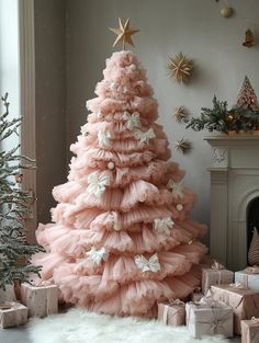 a pink christmas tree surrounded by presents