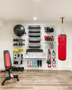 an exercise room with various equipment on the wall