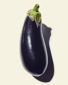 an eggplant is shown on a white background with shadow from the top down