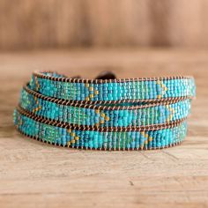 the turquoise and brown beaded bracelets are stacked on top of each other