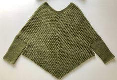 This crochet poncho sweater was made by hand in Stillwater, Minnesota. It's a flattering poncho that wears like a sweater because it has sleeves. Stitched in Cascade Yarns 100% Peruvian Wool, this piece is heirloom quality--it will last forever. The color is called Turtle and is a gorgeous green heather. I spent five years living in Seattle and this amazing city is the inspiration behind this project. The yarn comes from the Seattle area, and I find the combination of this beautiful wool worked Cozy Hand-knitted Long Sleeve Poncho, Cozy Hand Knitted Long Sleeve Poncho, Winter Crochet Poncho With Long Sleeves, Winter Crochet Long Sleeve Poncho, Fall Crochet Knit Poncho, Crochet Poncho Sweater, Peruvian Poncho, Living In Seattle, Stillwater Minnesota