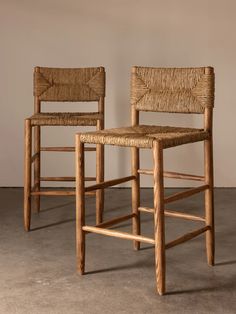 two wooden chairs sitting next to each other