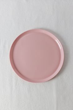 a pink plate sitting on top of a white table