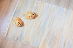 two small stuffed animals sitting on top of a rug