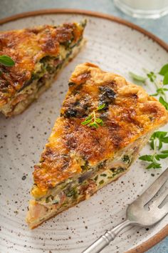 two slices of quiche on a plate with a fork