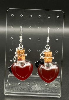 For all those vampire lovers out there or you just want to get into the spooky season, these blood vile earrings are for you.  They are heart shaped glasses filled with blood colored oil and topped off with a vampire lip charm. When getting the earrings, the dye will settle and will have to be shaken to get back to normal Blood Infused Jewelry, Vampire Lovers, Vampire Blood, Vampire Lips, Heart Shaped Glasses, Jewelry Halloween, Halloween Jewelry, Savannah Ga, Girls Jewelry