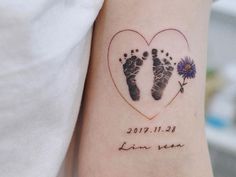 a couple's foot prints in the shape of a heart with flowers on it