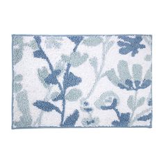 a blue and white bath mat with leaves on the bottom, in front of a white background