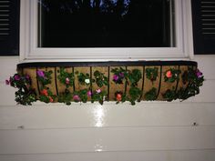 a window sill with flowers growing on it